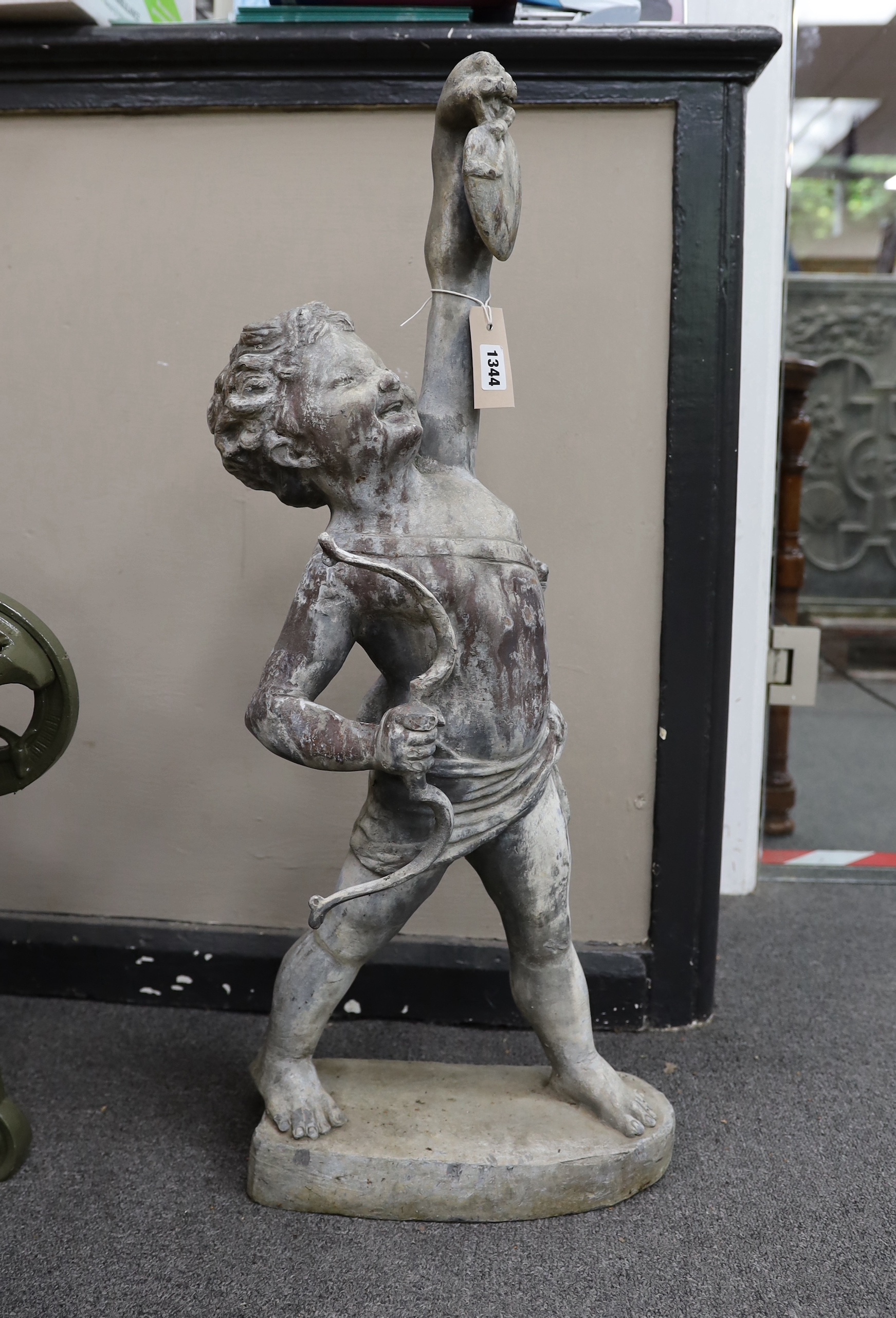 A Bromsgrove Guild lead garden ornament, “Love the Pedlar” with bow, height 80cm